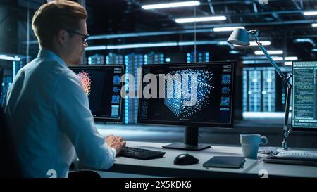 Information Technology Specialist and Data Center Administrator Working on Personal Computer, Monitoring Web Services, Cloud Computing, Analytics Facility, Performing Maintenance and Cyber Security Stock Photo
