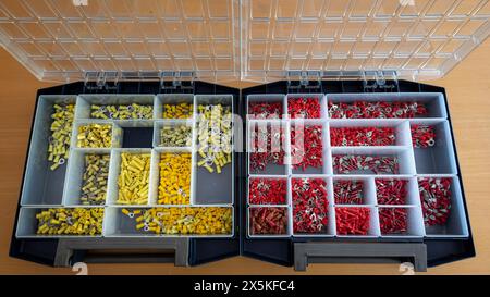 Boxes full of cable connectors and cable lugs in different colors and different sizes, suitable for electrical use Stock Photo