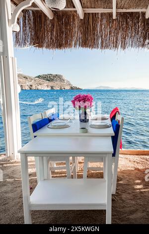 the table of a seaside restaurant set for a dinner on the beach Stock Photo