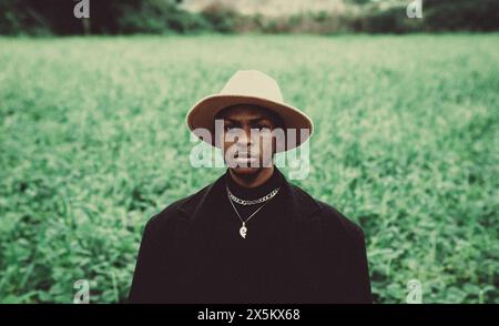 Nigeria, Delta state, Portrait of stylish man standing in field Stock Photo