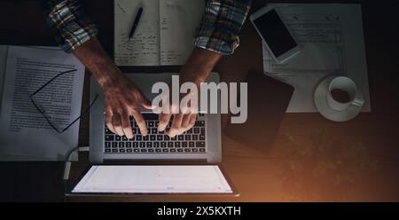 Businessman, programmer and typing on laptop in office with paperwork for data analytics, coding and software script. Top view, tech expert and Stock Photo