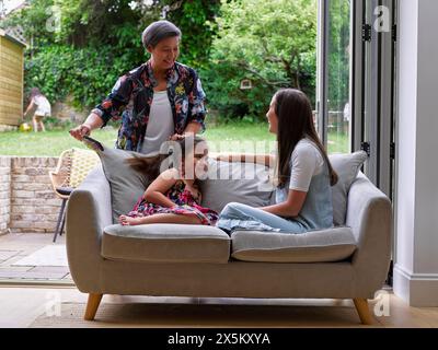 Family relaxing on sofa Stock Photo