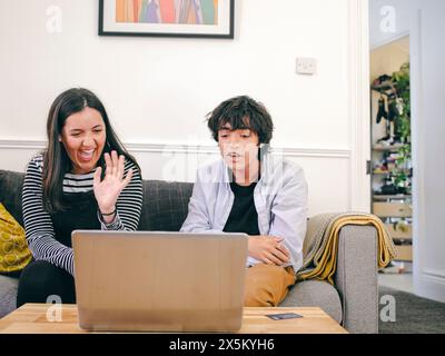 Brother and sister having video call via laptop Stock Photo - Alamy