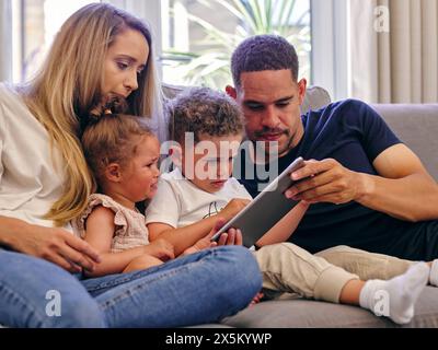 Parents with baby daughter and son at home Stock Photo