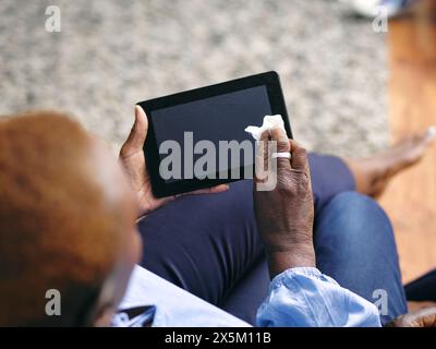 Woman cleaning digital tablet Stock Photo