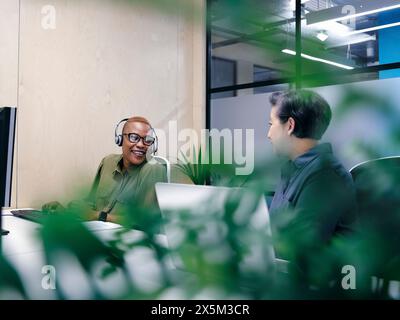 Office workers using computers in co-working office space Stock Photo