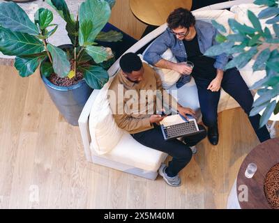 UK, London, Overhead view of coworkers relaxing in office lobby Stock Photo