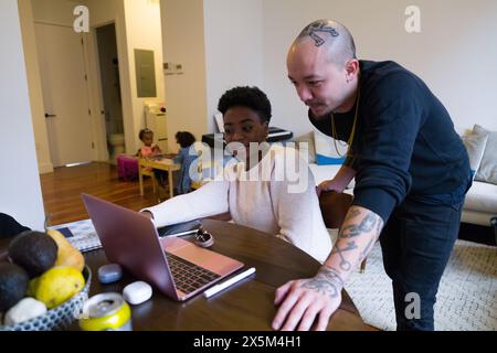 Couple working on laptop at home Stock Photo