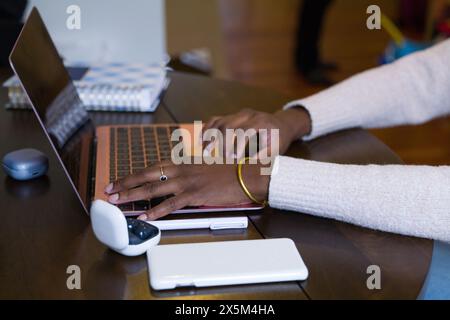 Woman using laptop, close up of hands Stock Photo