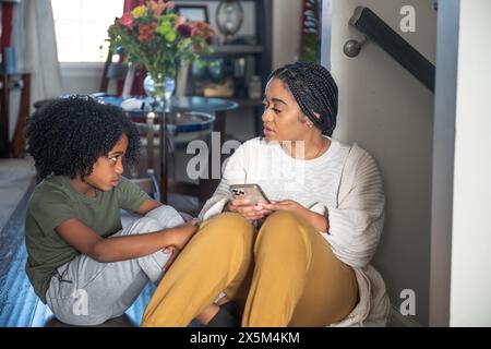 Mother talking with son at home Stock Photo