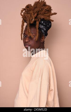 Studio portrait of young woman with dreadlocks Stock Photo