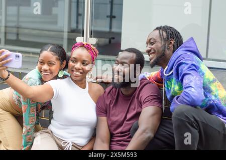 Group of smiling friends taking selfie outdoors Stock Photo