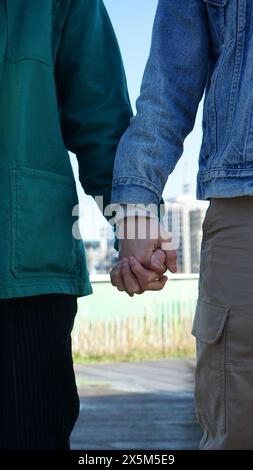 Close-up of gay couple holding hands Stock Photo