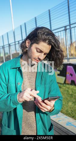 Man using smart phone outdoors Stock Photo
