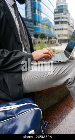 Midsection of business man using laptop Stock Photo