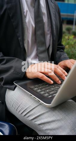 Midsection of business man using laptop Stock Photo