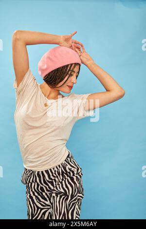 Studio shot of stylish woman against blue background Stock Photo