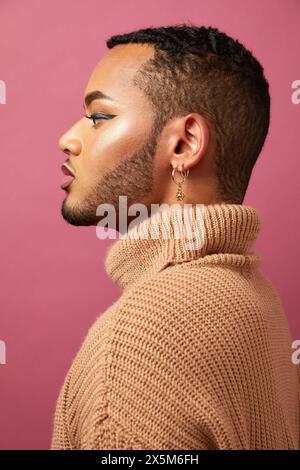 Profile of queer man against purple background Stock Photo