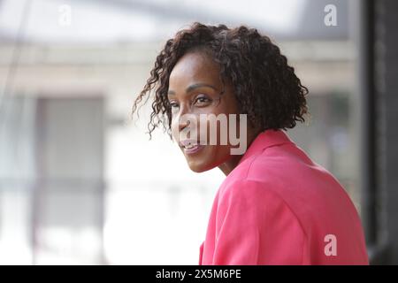 Smiling mature businesswoman in pink blazer Stock Photo