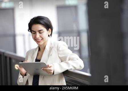 Smiling businesswoman using tablet Stock Photo