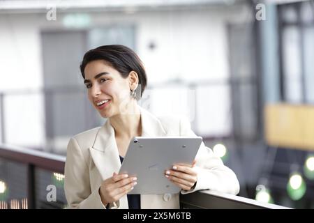 Smiling businesswoman using tablet Stock Photo