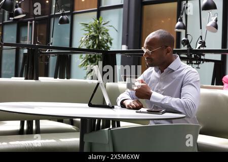 Businessman working in office and drinking coffee Stock Photo
