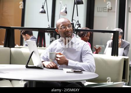 Businessman working in office and drinking coffee Stock Photo