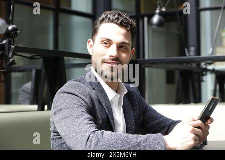 Smiling businessman using smart phone Stock Photo