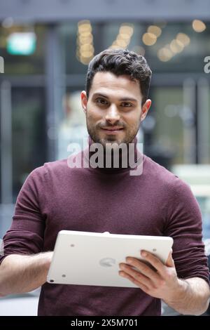 Portrait of young businessman using tablet in office Stock Photo