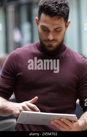 Young businessman using tablet in office Stock Photo