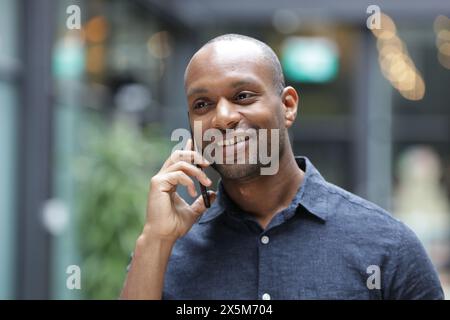 Smiling businessman talking on phone Stock Photo
