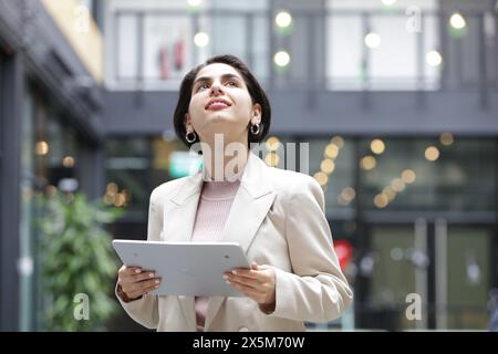 Young businesswoman using tablet in office Stock Photo