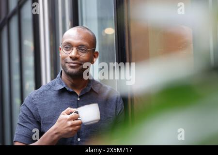 Businessman having coffee break in office Stock Photo