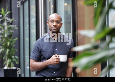 Businessman having coffee break in office Stock Photo