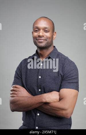 Portrait of smiling man with arms crossed Stock Photo