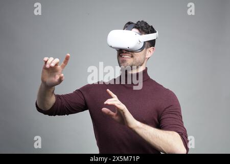 Young man wearing virtual reality headset and gesturing Stock Photo