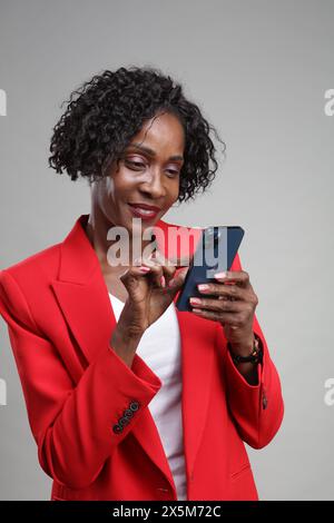 Smiling businesswoman using smart phone Stock Photo
