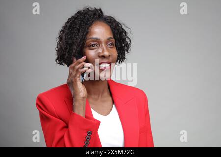 Smiling businesswoman talking on phone Stock Photo