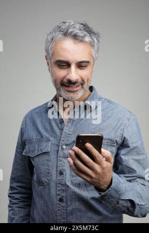 Mature man using smart phone Stock Photo