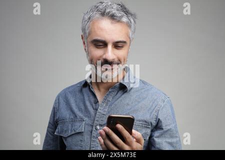 Mature man using smart phone Stock Photo