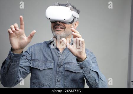 Mature man using virtual reality headset Stock Photo