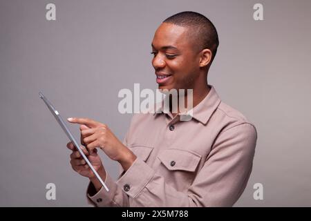 Smiling man using digital tablet Stock Photo