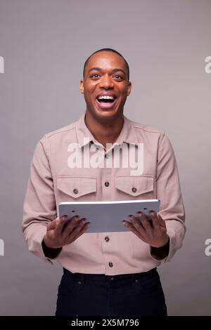 Man holding digital tablet and smiling Stock Photo