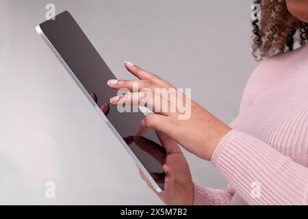 Close-up of female hands using digital tablet Stock Photo