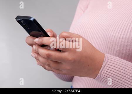Close-up of female hands using smart phone Stock Photo
