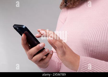 Close-up of female hands using smart phone Stock Photo