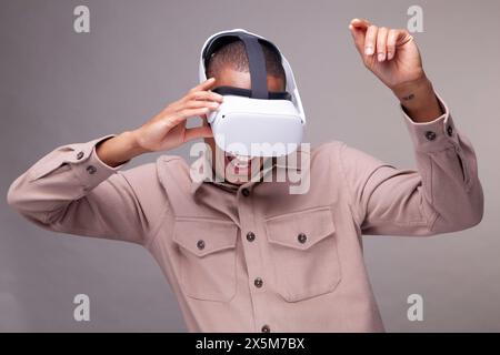 Man in virtual reality headset dancing Stock Photo