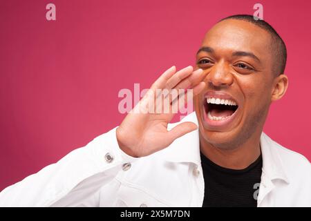 Smiling man shouting Stock Photo