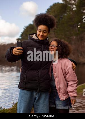 Two girls taking selfie outdoors Stock Photo