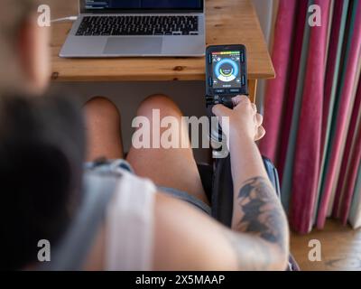 Woman in electric wheelchair using joystick with screen Stock Photo
